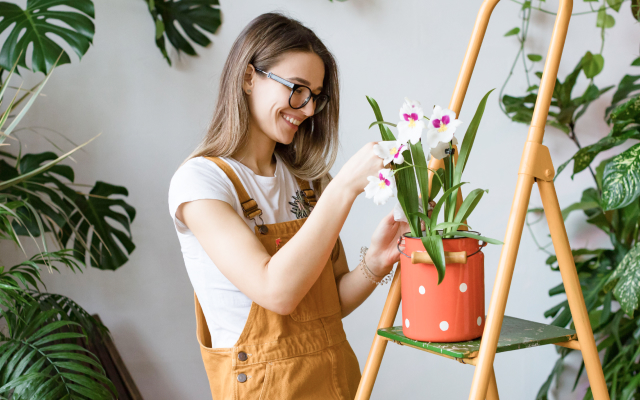 Woman smiling tending to plants