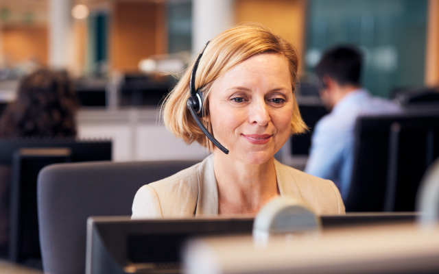 woman wearing headset and working at desktop
