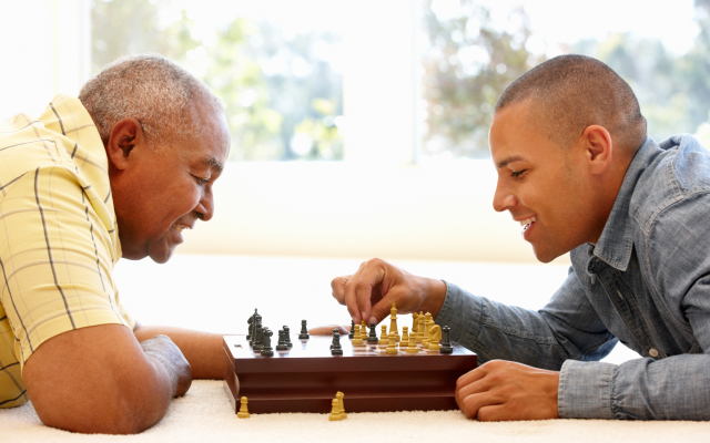 Elderly mand and a yonger man playing chess
