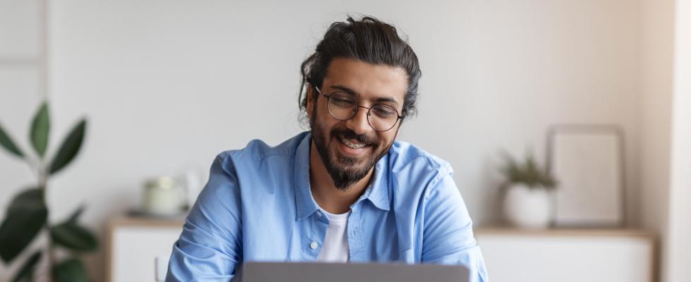 Man looking at laptop smiling