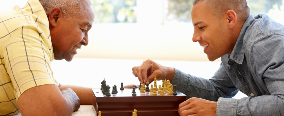 Older man and younger man playing chess