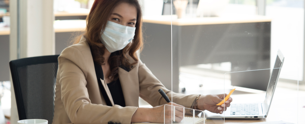 Woman wearing facemask at desk